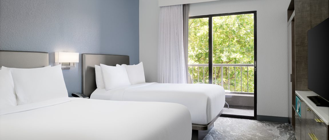 two double beds looking out to the trees